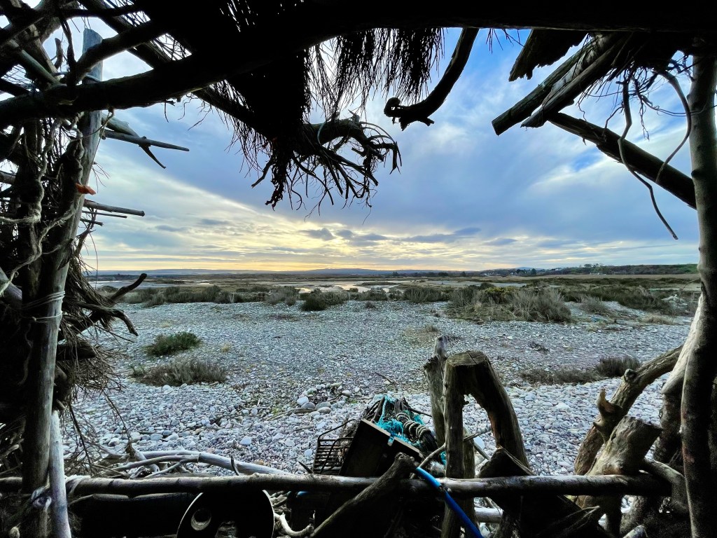 View of shingle beach out the beach hut window 
